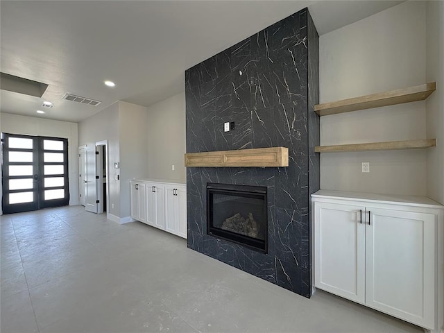 7225 NW 154th St, Edmond, OK 73013 - unfurnished living room featuring french doors, visible vents, recessed lighting, concrete flooring, and a fireplace
