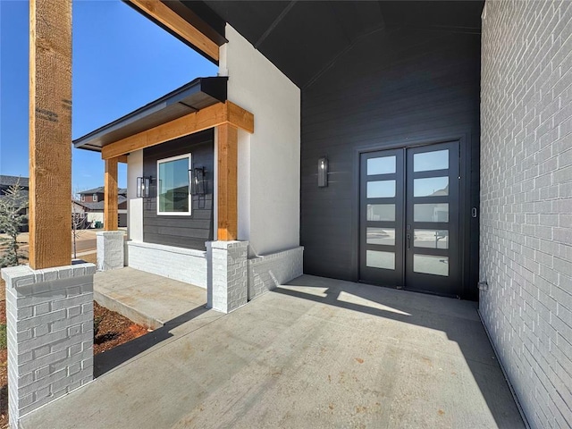 7225 NW 154th St, Edmond, OK 73013 - doorway to property with french doors and stucco siding