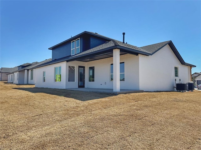 7225 NW 154th St, Edmond, OK 73013 - rear view of property with brick siding, cooling unit, and a patio