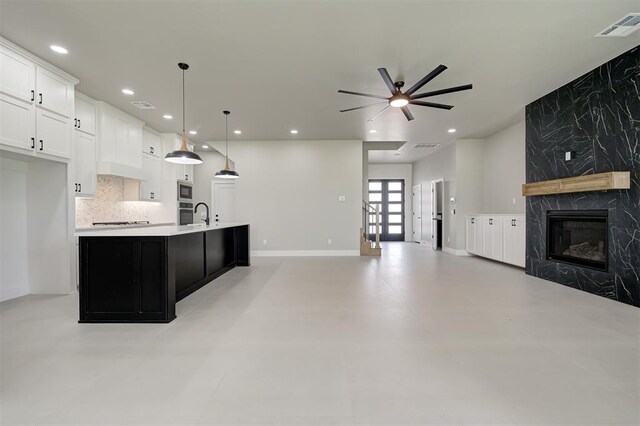 7225 NW 154th St, Edmond, OK 73013 - kitchen with a ceiling fan, a fireplace, open floor plan, light countertops, and recessed lighting