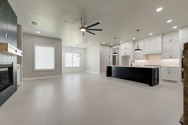 7225 NW 154th St, Edmond, OK 73013 - kitchen with decorative backsplash, a tile fireplace, ceiling fan, open floor plan, and recessed lighting