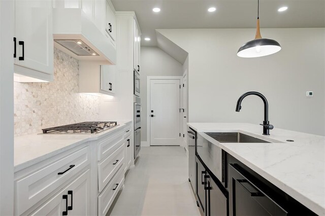 7225 NW 154th St, Edmond, OK 73013 - kitchen with stainless steel appliances, decorative backsplash, light stone countertops, white cabinetry, and premium range hood
