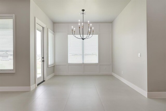 7225 NW 154th St, Edmond, OK 73013 - unfurnished dining area with a chandelier, plenty of natural light, and light tile patterned floors