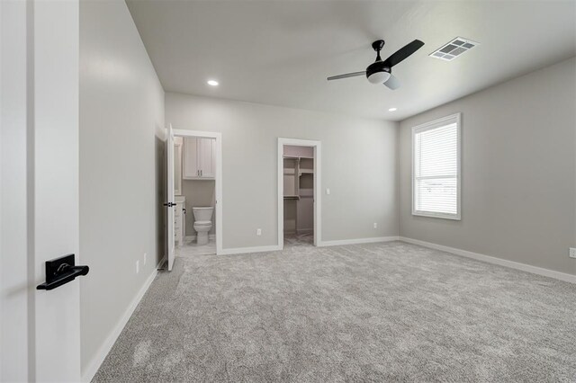 7225 NW 154th St, Edmond, OK 73013 - unfurnished bedroom with a spacious closet, light carpet, recessed lighting, ensuite bathroom, and a ceiling fan