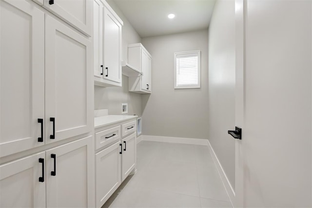 7225 NW 154th St, Edmond, OK 73013 - washroom featuring cabinet space, light tile patterned floors, and hookup for a washing machine