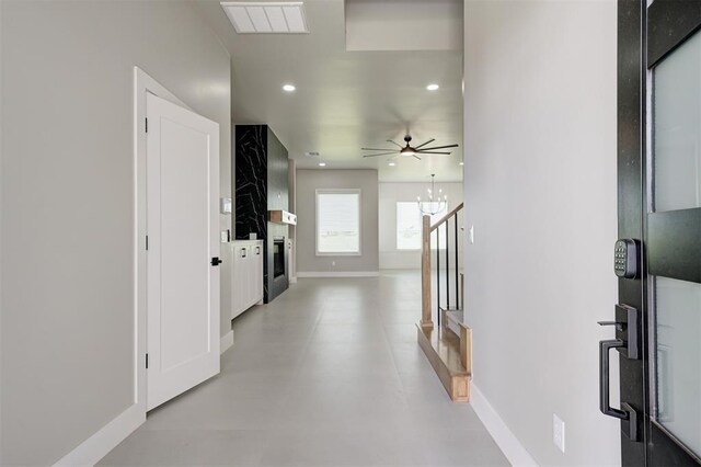 7225 NW 154th St, Edmond, OK 73013 - hall featuring recessed lighting, finished concrete flooring, and a chandelier