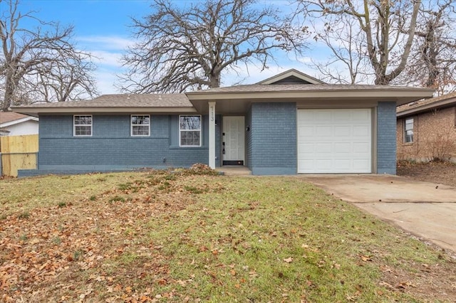 ranch-style house with a garage and a front lawn