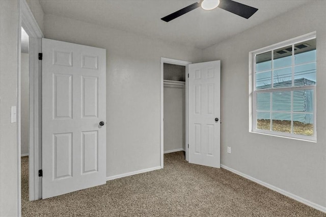 unfurnished bedroom featuring light carpet, ceiling fan, and a closet