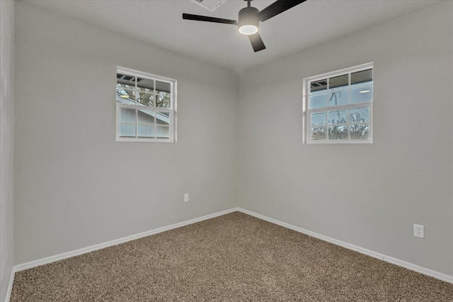 carpeted empty room with plenty of natural light and ceiling fan