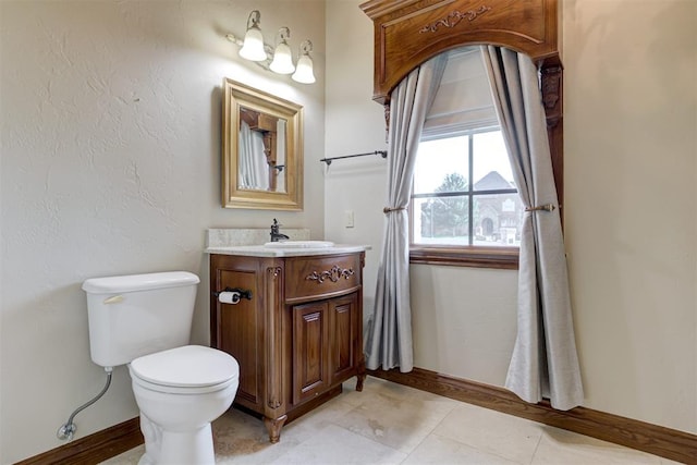 bathroom with vanity, toilet, and tile patterned flooring