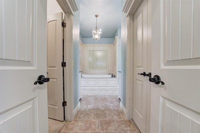 corridor with a notable chandelier