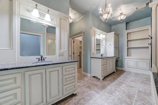 bathroom with vanity and an inviting chandelier