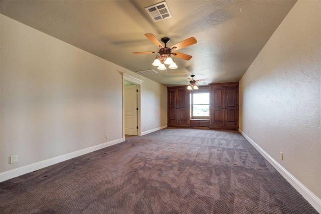 carpeted spare room with ceiling fan and a textured ceiling