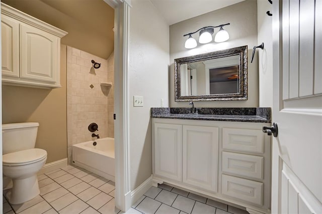 full bathroom featuring tiled shower / bath, vanity, toilet, and tile patterned flooring