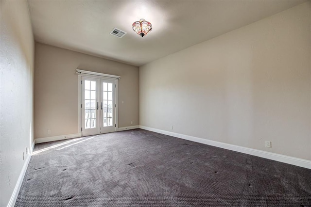 carpeted spare room with french doors