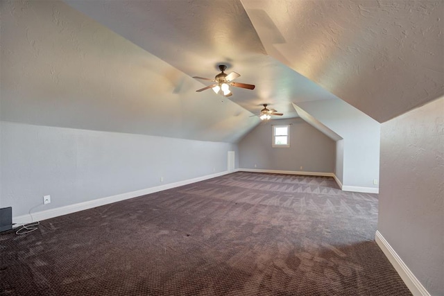 additional living space featuring ceiling fan, carpet floors, vaulted ceiling, and a textured ceiling