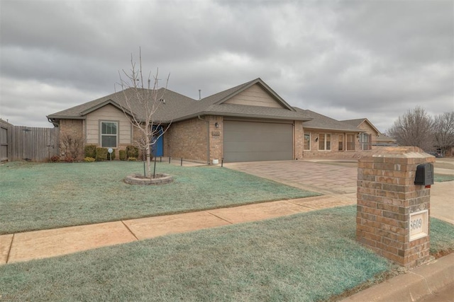 ranch-style home featuring a garage and a front yard