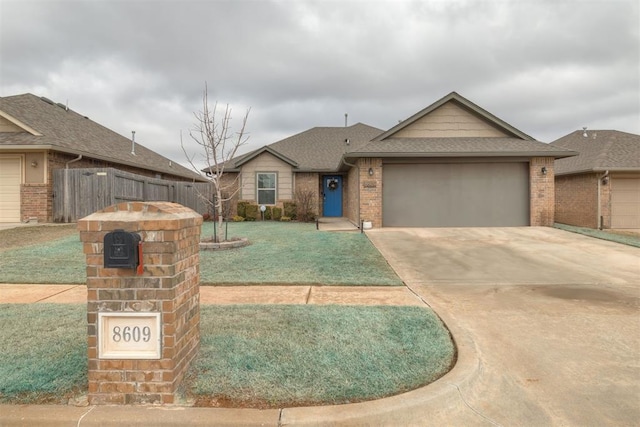 view of front of property with a garage and a front lawn