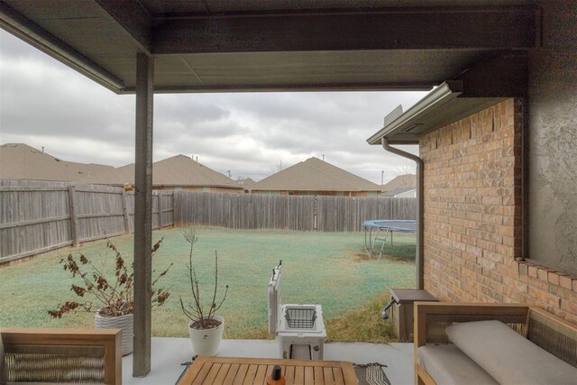 8609 SW 36th Ter, Oklahoma City, OK 73179 - fenced backyard with a trampoline and a patio