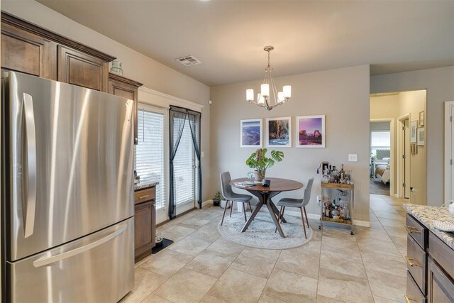 8609 SW 36th Ter, Oklahoma City, OK 73179 - dining room featuring a chandelier and light tile patterned flooring