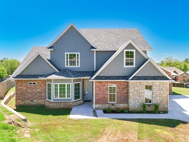 1909 Carleton Ln, Shawnee, OK 74804 - view of front of house with roof with shingles, a front lawn, and brick siding