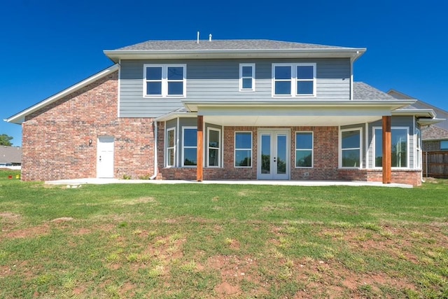 1909 Carleton Ln, Shawnee, OK 74804 - rear view of property featuring a yard, a patio area, french doors, and brick siding