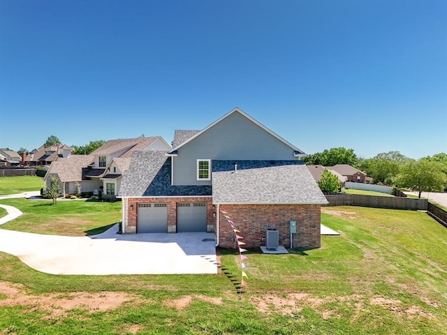 1909 Carleton Ln, Shawnee, OK 74804 - view of side of home with a lawn, fence, brick siding, and driveway
