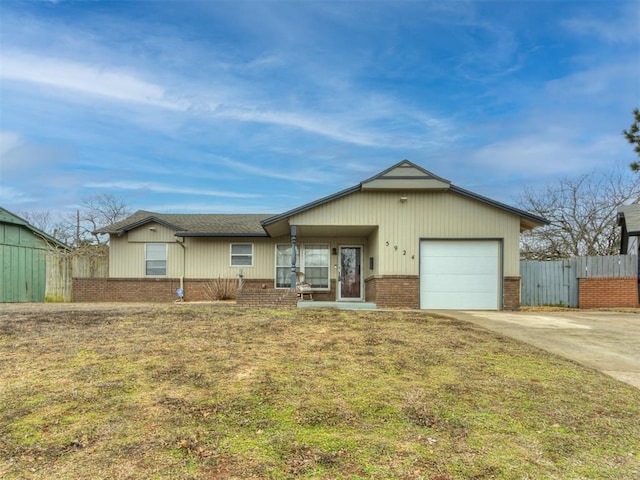 ranch-style house featuring a garage and a front lawn