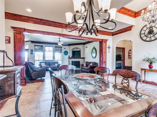 tiled dining room with crown molding and ceiling fan with notable chandelier