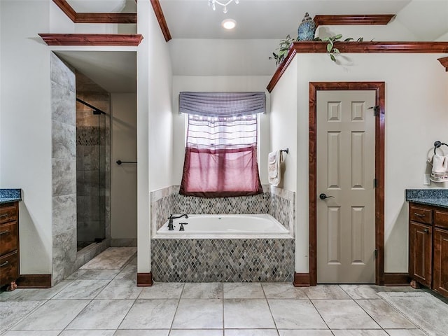 bathroom with tile patterned floors, vanity, and shower with separate bathtub