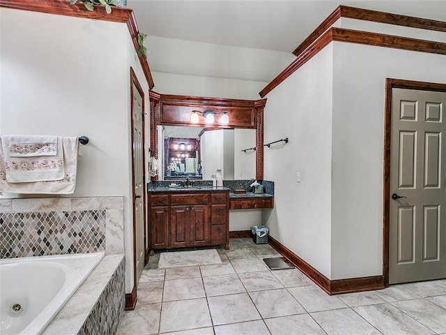 bathroom with tile patterned floors, vanity, and tiled tub