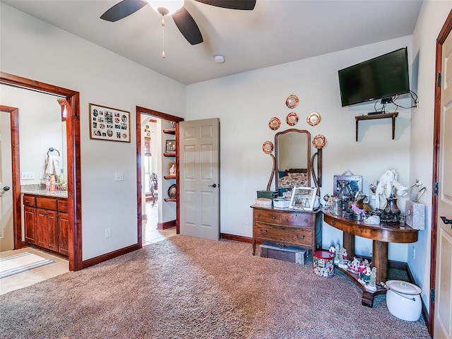 carpeted bedroom featuring ensuite bath and ceiling fan