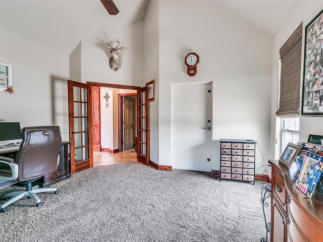 carpeted home office featuring high vaulted ceiling and french doors