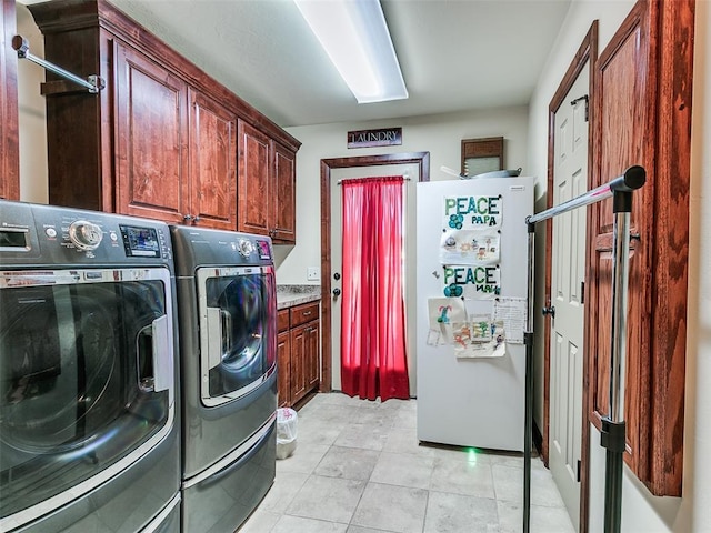 clothes washing area with cabinets, light tile patterned floors, and independent washer and dryer