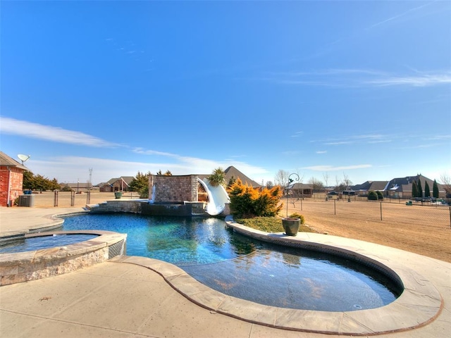 view of swimming pool with an in ground hot tub