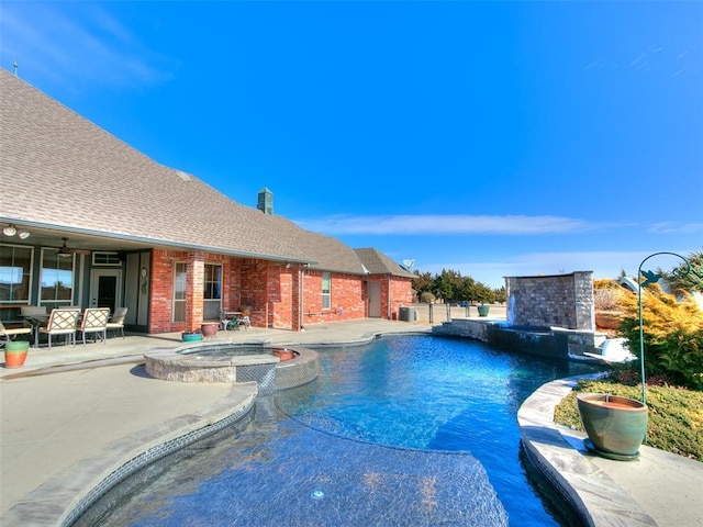 view of pool featuring a patio area and an in ground hot tub