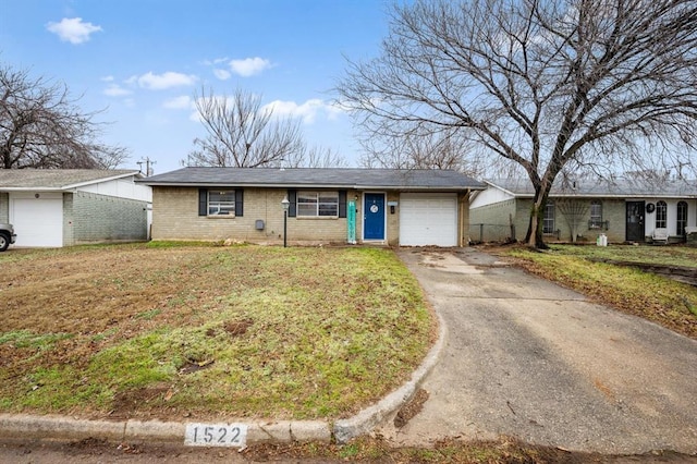 single story home with a garage and a front lawn