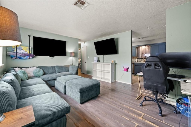 living room featuring dark hardwood / wood-style flooring and a textured ceiling