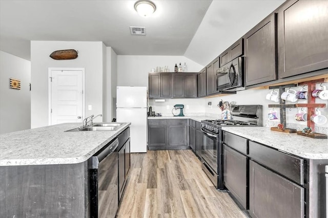 kitchen with sink, gas stove, light hardwood / wood-style flooring, white refrigerator, and dishwasher