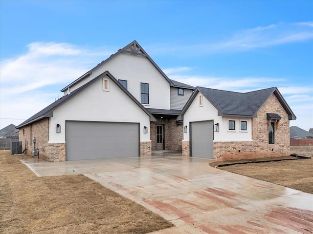 view of front of property with a garage, central AC, and a front yard