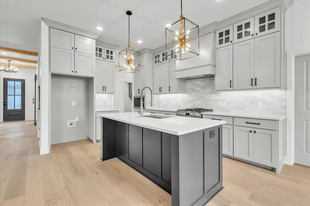 3305 Sugar Maple Way, Oklahoma City, OK 73179 - kitchen featuring a chandelier, an island with sink, light wood-style flooring, tasteful backsplash, and recessed lighting