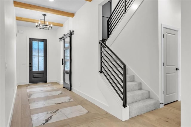 3305 Sugar Maple Way, Oklahoma City, OK 73179 - entryway featuring stairway, beamed ceiling, a barn door, light marble finish floors, and a chandelier
