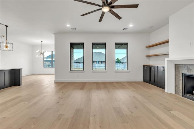 3305 Sugar Maple Way, Oklahoma City, OK 73179 - unfurnished living room with a fireplace, a ceiling fan, a chandelier, light wood-type flooring, and recessed lighting