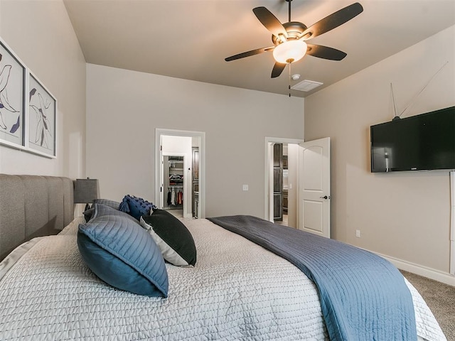 bedroom featuring ceiling fan, carpet flooring, and a spacious closet