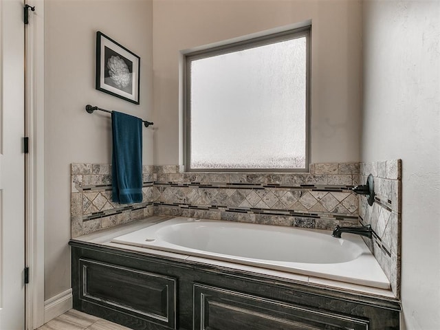 bathroom with tiled bath