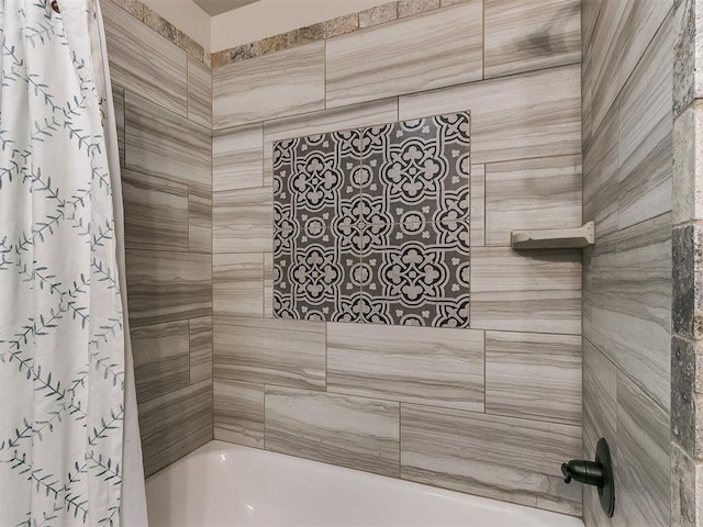 bathroom with shower / bath combo with shower curtain