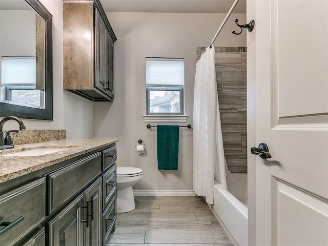 full bathroom featuring vanity, plenty of natural light, shower / bathtub combination with curtain, and toilet