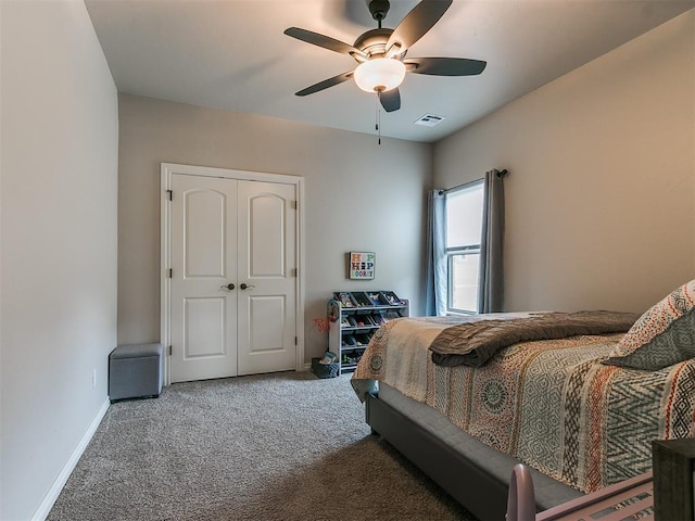 carpeted bedroom featuring ceiling fan and a closet