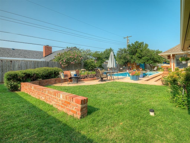 view of yard with a fenced in pool and a patio