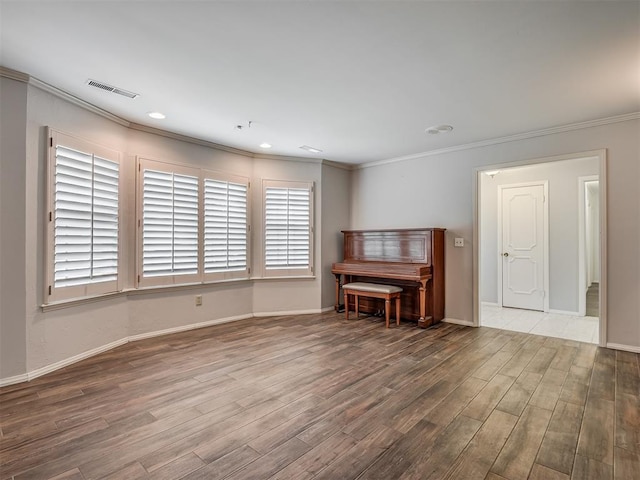 interior space featuring hardwood / wood-style flooring and ornamental molding